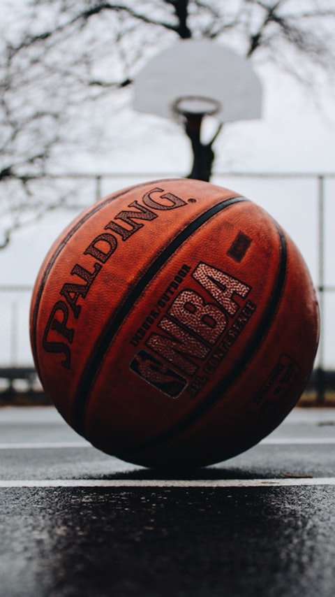 Basketball on an outdoor court under the hoop