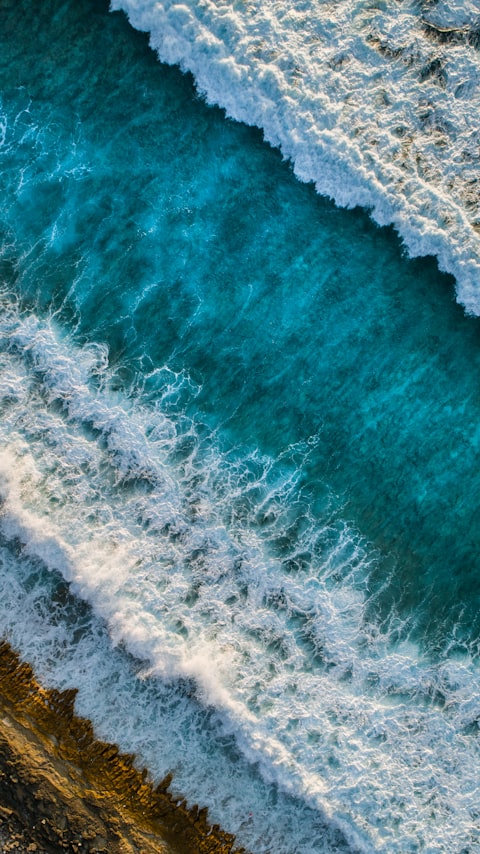 Drone shot of waves along the coastline